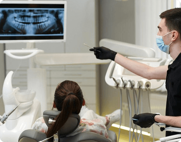 Dentist performing dental examination with patient